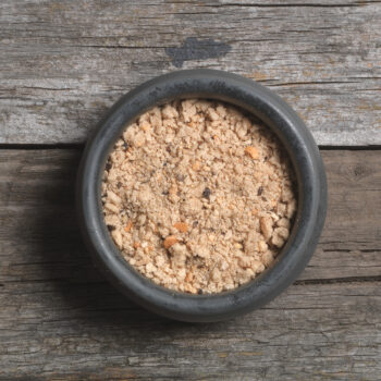 A rustic bowl filled with Arthur Pipkins Premium Cumberland Sausage Mix, a professional-grade seasoning available from Parkers Food Machinery Plus.