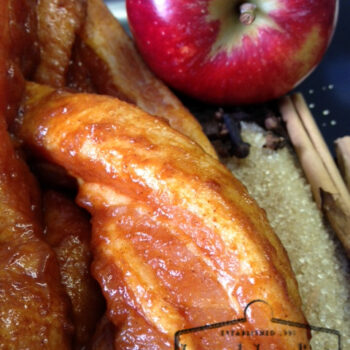 Glazed meat with apple, brown sugar, and cinnamon sticks, showcasing a sweet and savory flavor profile. Featured by Leonard's Ingredients