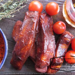 Parkers Food Machinery Plus Sizzling glazed meat, fresh tomatoes, and spices, showcasing results achievable with Leonards Gluten Free Bourbon BBQ Glaze 2.27kg Tub.