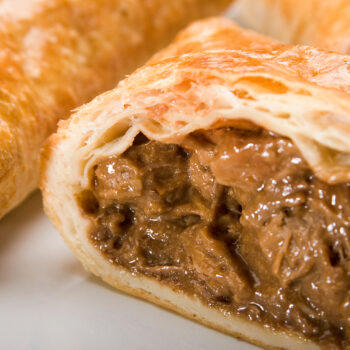 Golden flaky steak slice pastry filled with tender beef and rich onion gravy. Made using Dalesman Steak Slice Gravy Mix, available from Parkers Food Machinery Plus