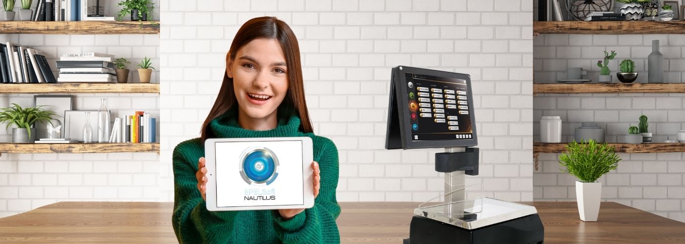 Woman presenting Deep Soft NAUTILUS software interface in modern tech workspace with touchscreen device and tablet display