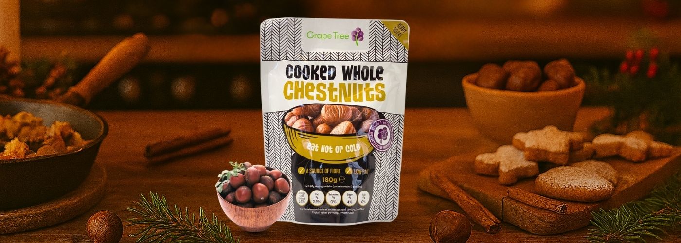 Festive kitchen scene with Grape Tree Cooked Whole Chestnuts pack, roasted chestnuts, and Christmas treats – PFM Plus holiday food promotion.