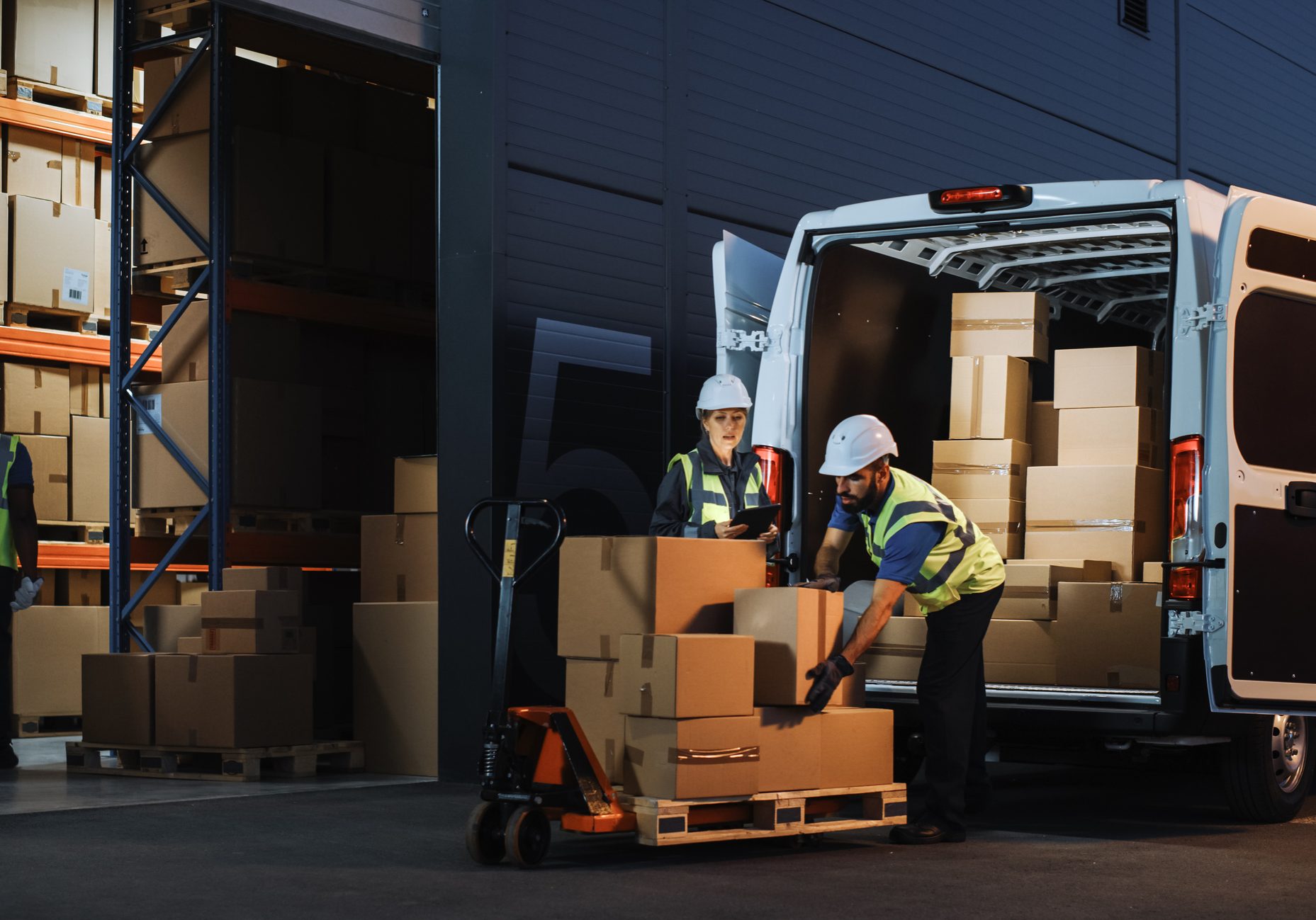 Outside of Logistics Retail Warehouse With Inventory Manager Using Tablet Computer, talking to Worker Loading Delivery Truck with Cardboard Boxes, Online Orders, Food and Medicine Supply, E-Commerce