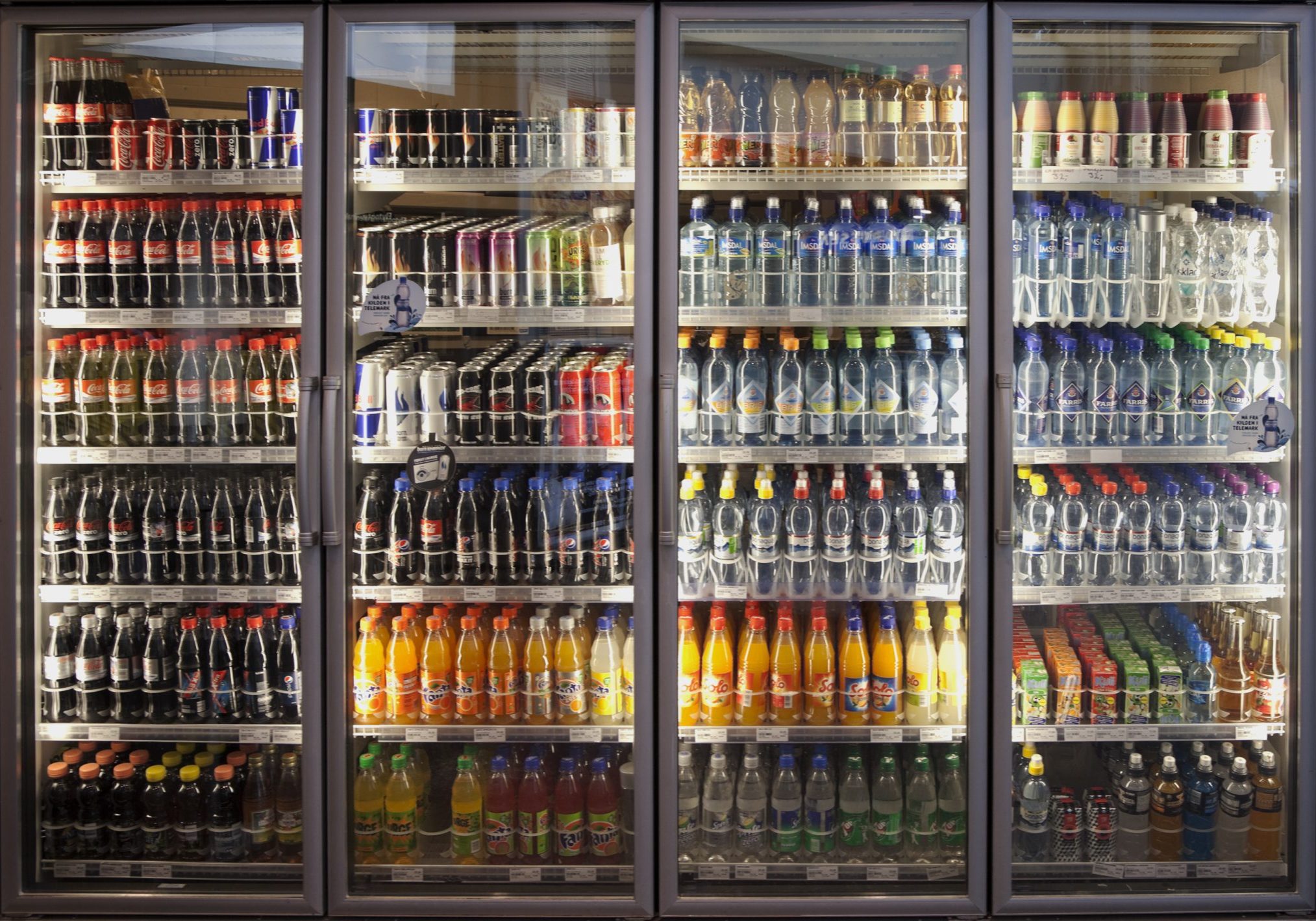 Oslo, Norway-February 22, 2011: Illuminated cooling shelf with a diverse range of soft drinks in a shop on the main train station selling refreshments.